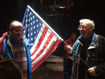 Theatre Group member with one of the props an American flag