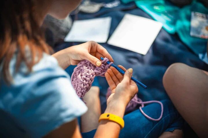 lady making a scarf to illustrate new knitting group