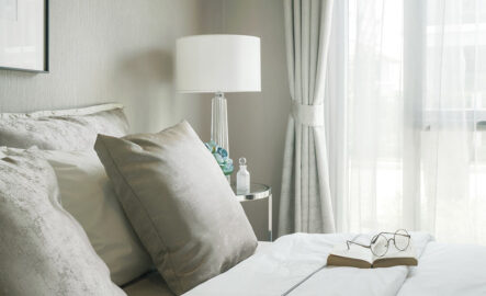 a bed with a book lying open on it
