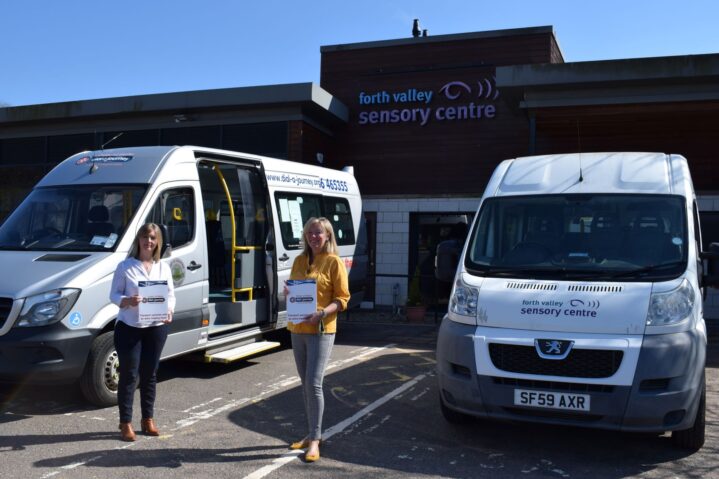 Heidi from Dial a Journey with Jacquie Winning outside the Centre with two minibuses