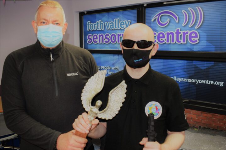 Alan Bell (left) presenting David with his award at the sensory centre
