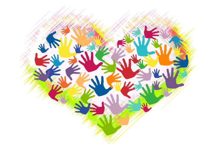 multi coloured hands in a heart shape