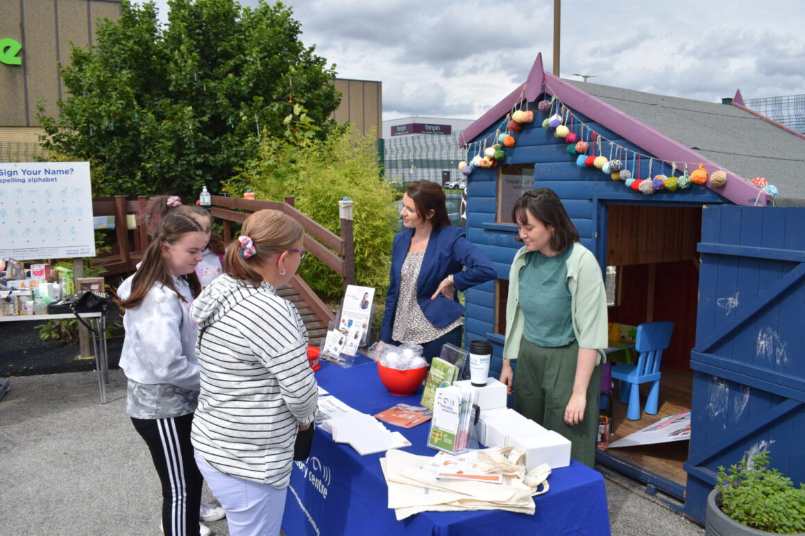 Six people standing at employment and energy table