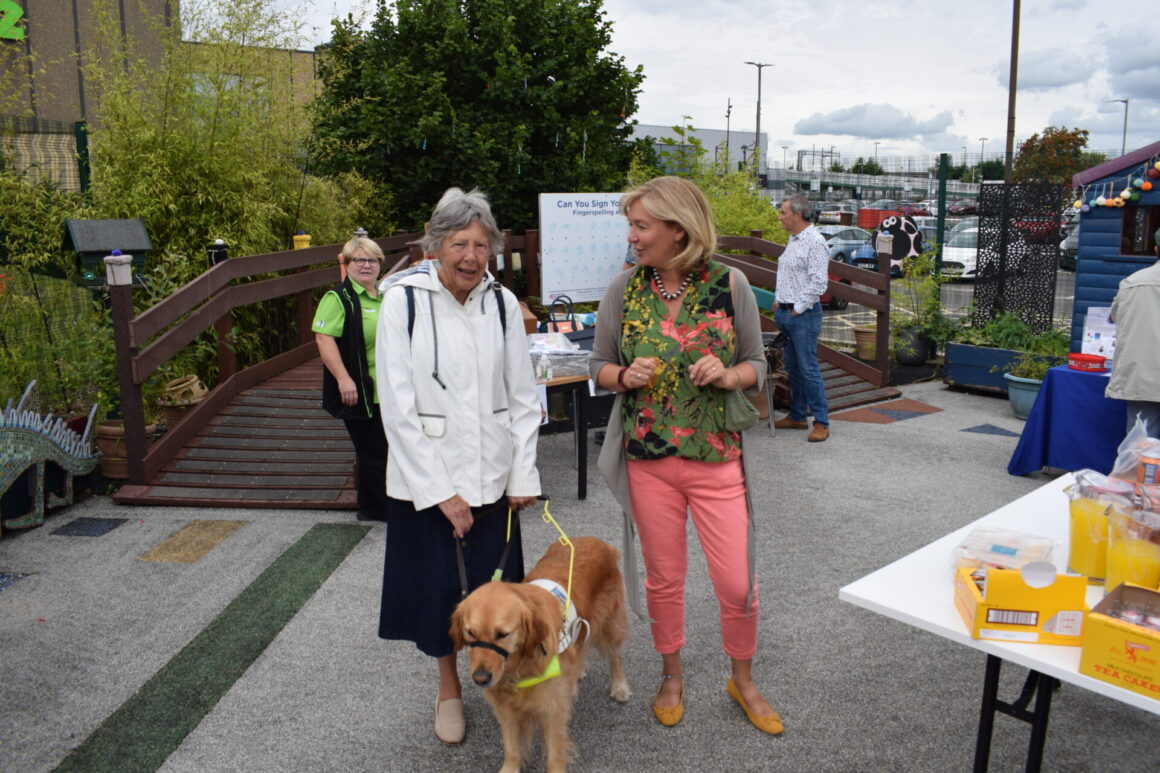 Jacquie with oun of our visitors and a guide dog