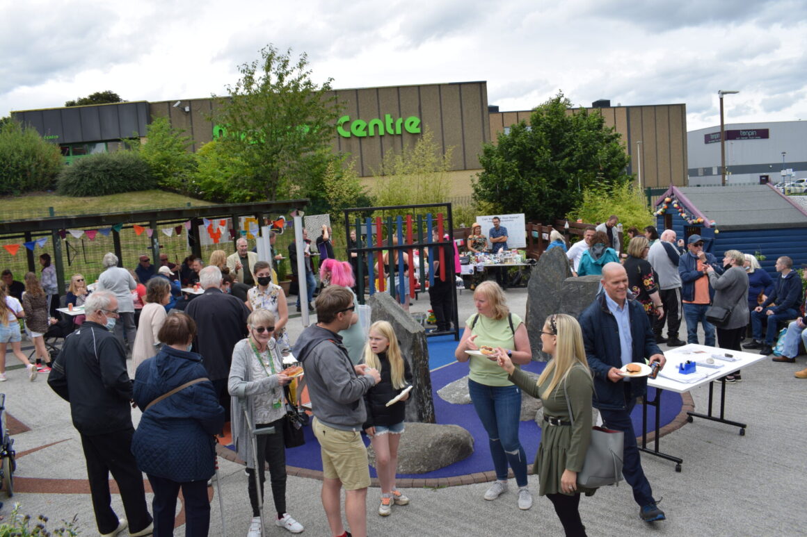 large image of sensory garden showing lots of people having fun and laughing