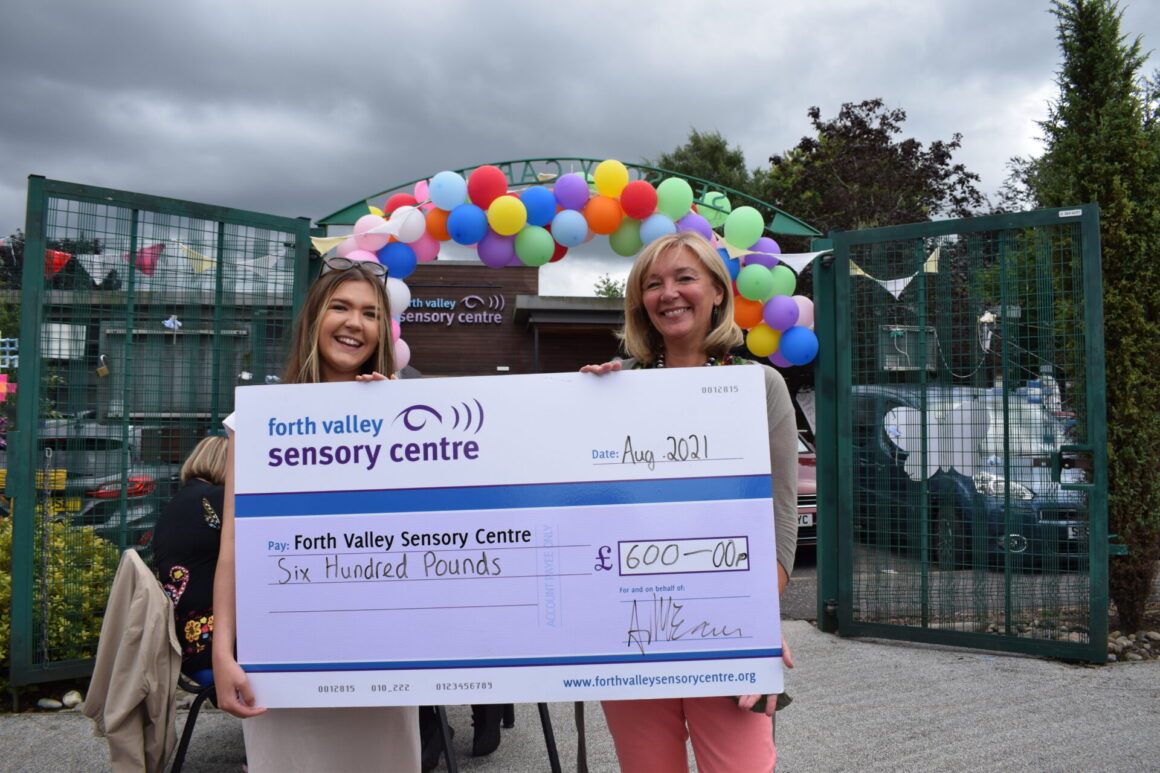 Amy and Jacquie holding our big charity cheque