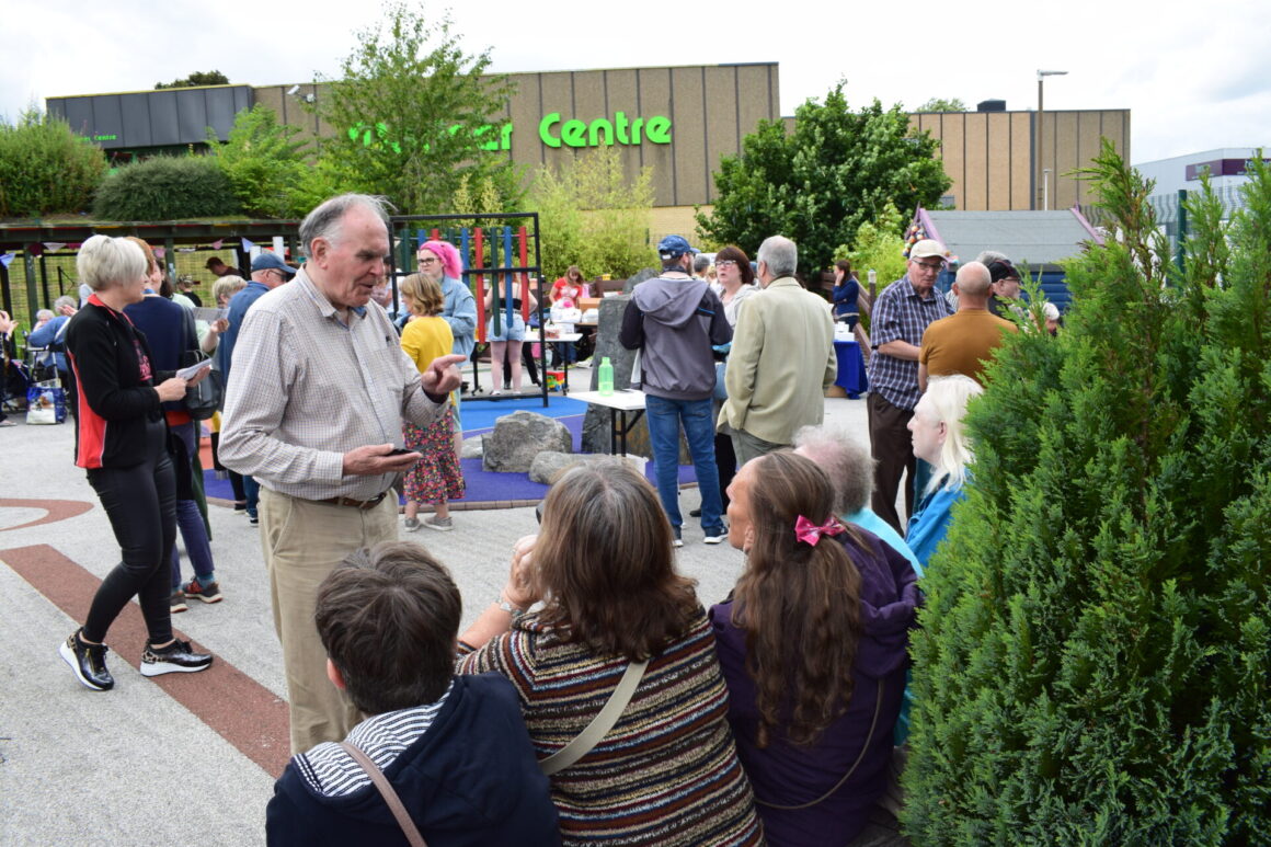Pat Reid speaking to seated guests at the Summer BBQ