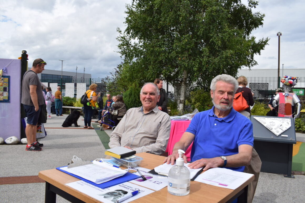 Pat Reid and Terry Robinson at the entry desk for the Summer BBQ