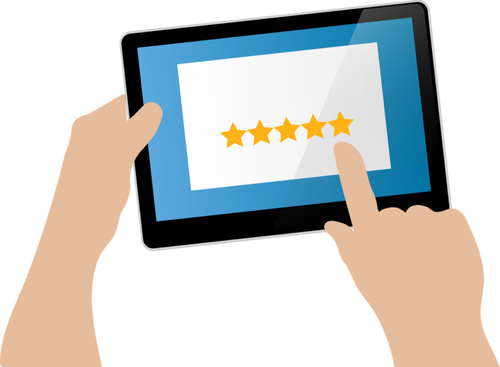 Computer image of someone selcting five stars on a tablet device