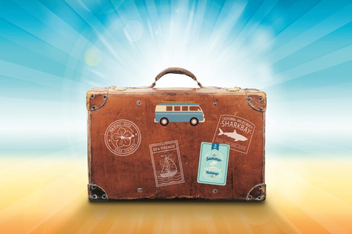 Suitcase with a beach and blue sky background