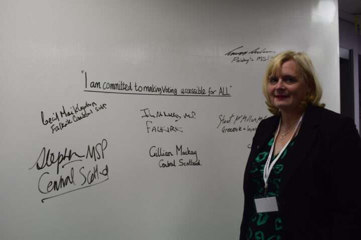 Cecil Meiklejohn with pledge wall