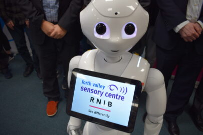 Pepper the guide robot with RNIB and Sensory Centre logos