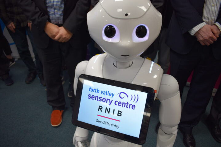 Pepper the guide robot with RNIB and Sensory Centre logos
