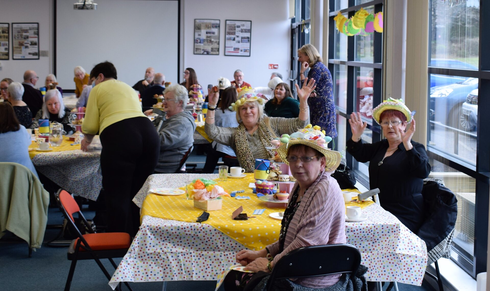 View of busy halls. Lady in the foreground wears a spring themed hat