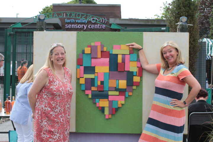 Jacquie and Val standing next to our new Tactile Heart in Sensory garden.