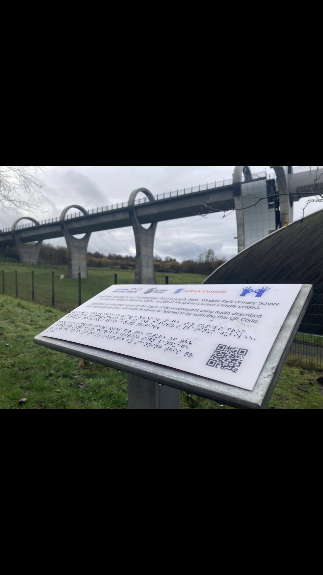 A plaque that describes details of the event with Braille and a QR code that leads to a video of the Pupils discussing what they want the world to look like in 70 years' time.