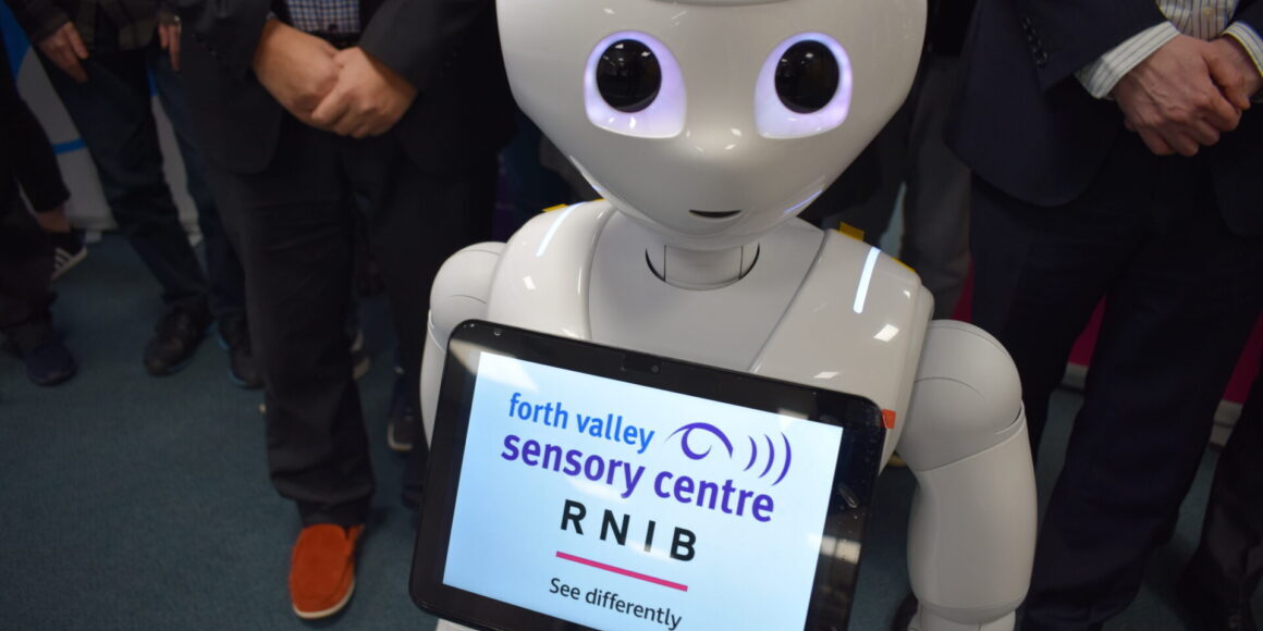 Pepper the guide robot with RNIB and Sensory Centre logos