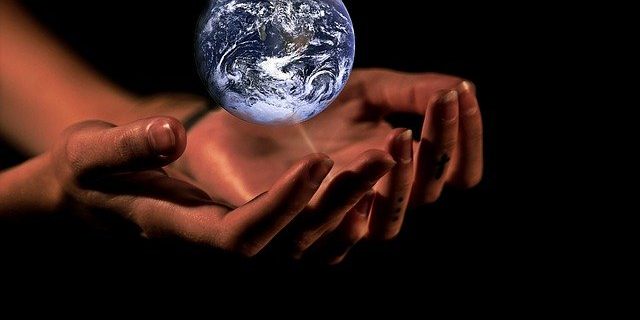 hands with a globe/earth